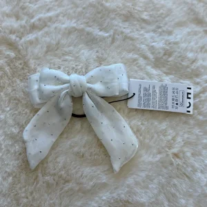 Laccetto per capelli con fiocco bianco